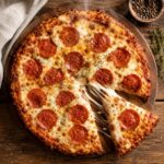 Carnivore pizza with a crispy golden cheese crust and melted mozzarella