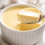 silky carnivore custard served in a white ramekin with a creamy spoonful