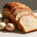 Sliced carnivore bread with eggs illustrating why carnivore bread can taste eggy